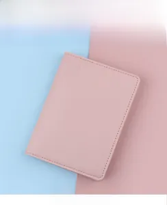 Pink leather passport holder with embossed airplane logo and detailed stitching