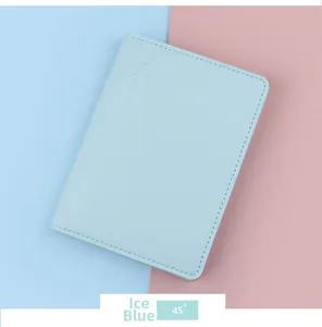 Detailed view of ice blue passport cover with lychee grain leather and airplane emboss