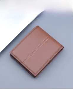Macro shot of brown leather wallet featuring detailed double yellow decorative stitching