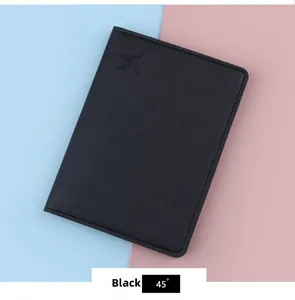 Close-up of minimalist black passport cover with embossed airplane icon on leather