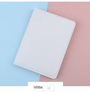 Close-up of white leather passport cover with an embossed airplane pattern on a blue background