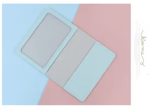 Detail view of mint green passport cover with transparent ID window and card slots