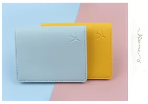 Detailed view of light blue and yellow passport covers with embossed airplane icons