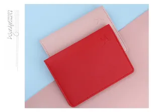 Detailed view of red and pink passport covers with embossed airplane logo and leather texture