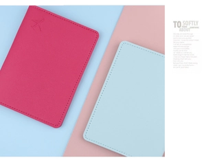 Detail showing the fine PU leather texture and embossed plane icon on passport covers