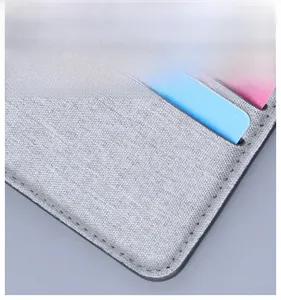 Detail of grey canvas wallet featuring rounded corners and internal card slots