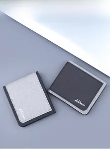Detail of dark and light gray minimalist canvas wallets with durable woven texture and stitching