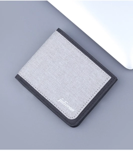 Close-up of minimalist bifold canvas wallet for men featuring textured gray fabric