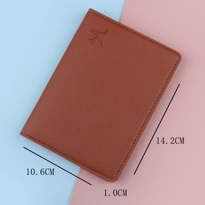 Brown leather travel passport holder with airplane embossing and 14.2x10.6cm dimensions