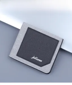 Close-up of minimalist grey canvas men's wallet showing fine fabric texture and logo
