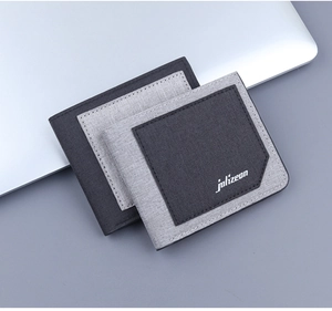 Slim canvas wallets in grey and light grey showing thin profile and fabric texture