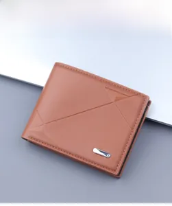 Macro view of brown leather wallet with geometric embossing and metal detail