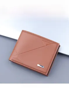 Detail of a brown short wallet with geometric textures and a small metal logo plaque