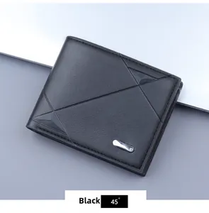 Detail of black leather wallet with geometric texture and silver metal accent