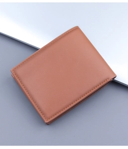 Detailed view of the fine stitching and texture on a brown bifold men's leather wallet