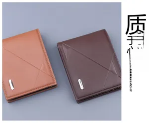 Detail of embossed leather wallets in light and dark brown with metal logo accent