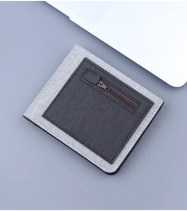 Detail of grey canvas bifold wallet featuring front zipper pocket and fabric texture