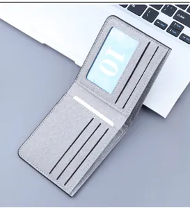 Detail view of grey canvas bifold wallet interior showing card slots and ID window