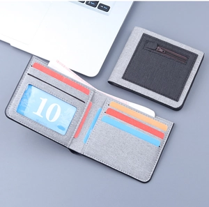 Detailed view of gray canvas men's wallet showing multiple card slots and zipper pocket