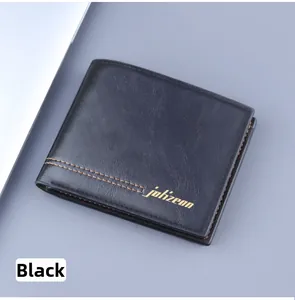 Detail of black bifold leather wallet featuring lychee texture and orange stitching
