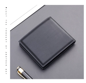 Flat lay of a slim black leather wallet for men with precise stitching on textured background