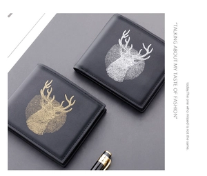 Close-up of slim men's bi-fold wallet featuring stylish stag head prints in gold and silver