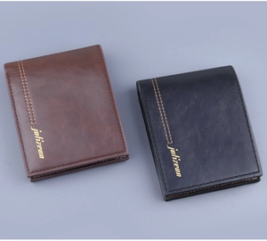 Detailed top view of brown and black bifold men's wallets with texture and stitching
