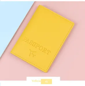 Close-up of yellow PU leather passport cover with embossed airplane icon and text