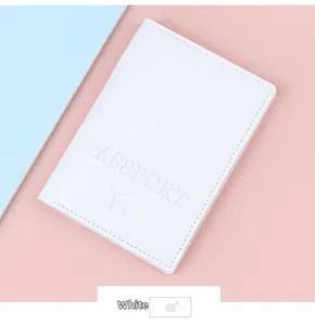 Detail view of white PU leather passport cover with embossed logo and fine edge stitching