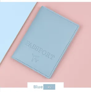 Detail of light blue embossed passport holder with airplane icon and text on color block background