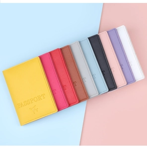 Flat lay of colorful cross-grain PU leather passport covers with embossed PASSPORT text