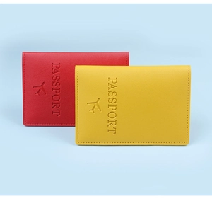 Detailed close-up of premium leather passport covers with airplane emblem and stitching