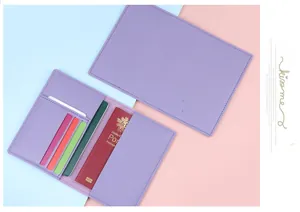 Macro detail of purple leather passport holder with four card slots and embossed icons