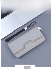 Detailed 45-degree view of grey canvas men's clutch with mesh design and wrist strap