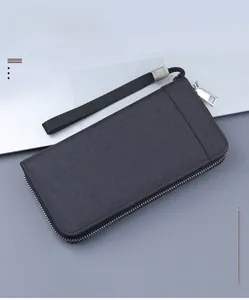 Detail view of charcoal gray canvas long wallet with zipper and wrist strap texture