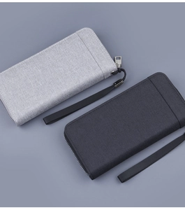 Close-up of canvas texture and zip puller on long wallets in light and dark grey