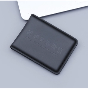 Close-up of black genuine leather driving license cover with elegant stitched edges