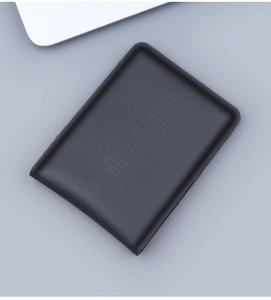 Close-up of black leather driver's license holder with pebbled texture and fine stitching