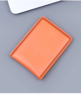 Macro view of orange genuine leather driving license holder with fine stitching and embossing