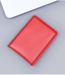 Macro detail of red litchi grain leather driving license cover with embossed text
