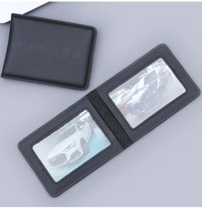 Macro view of black leather driving license wallet with dual clear card slots