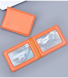 Detailed view of orange leather driving license wallet with dual clear ID windows