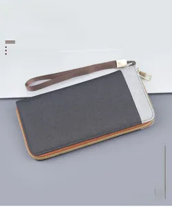 Detailed macro view of the canvas fabric texture and metal zipper on men long clutch wallet
