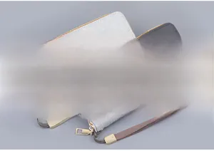 Detail of dual-color canvas wristlet clutches with gold zippers and fabric wrist straps