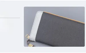 Close-up of canvas men clutch with golden zipper and leather strap detail