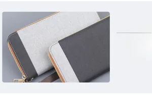Detail view of large canvas clutch wallet with dual-tone grey stitch and gold zipper