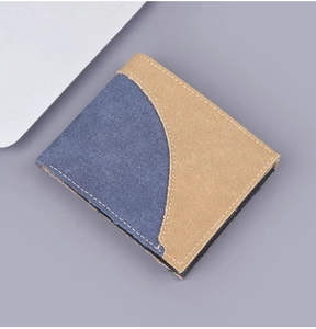 Detail of minimalist denim canvas wallet with contrast stitching and multi-color paneling