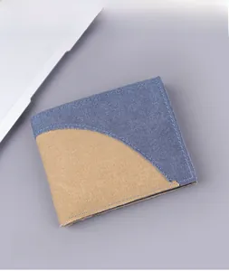 Detail view of denim canvas bifold wallet with contrast blue and khaki stitching