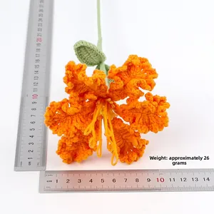 Detailed view of handmade crochet orange flower with ruler showing 14cm diameter size