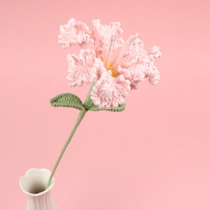 Handmade crochet pink lily flower in a white vase with soft fiber knit details